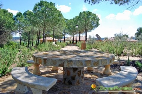 Mesas y sillas de piedra en el recinto de Casas Rurales El Pinar